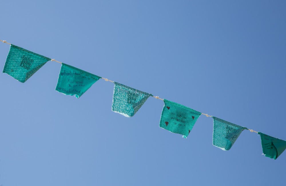 Teal flags are displayed along Grand River Avenue on April 3, 2019.